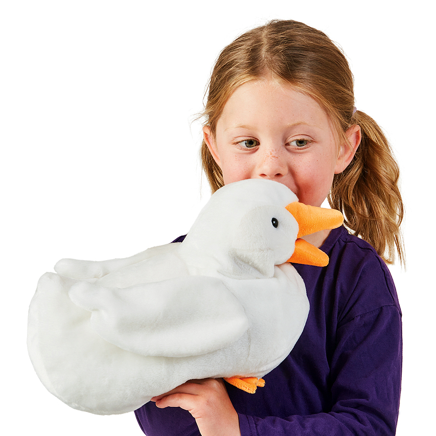 Girl hugging a white Folkmanis duck hand puppet with an orange beak and feet