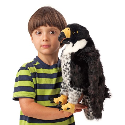 Folkmanis peregrine falcon hand puppet with black plumage, yellow beak and talons, held by a child