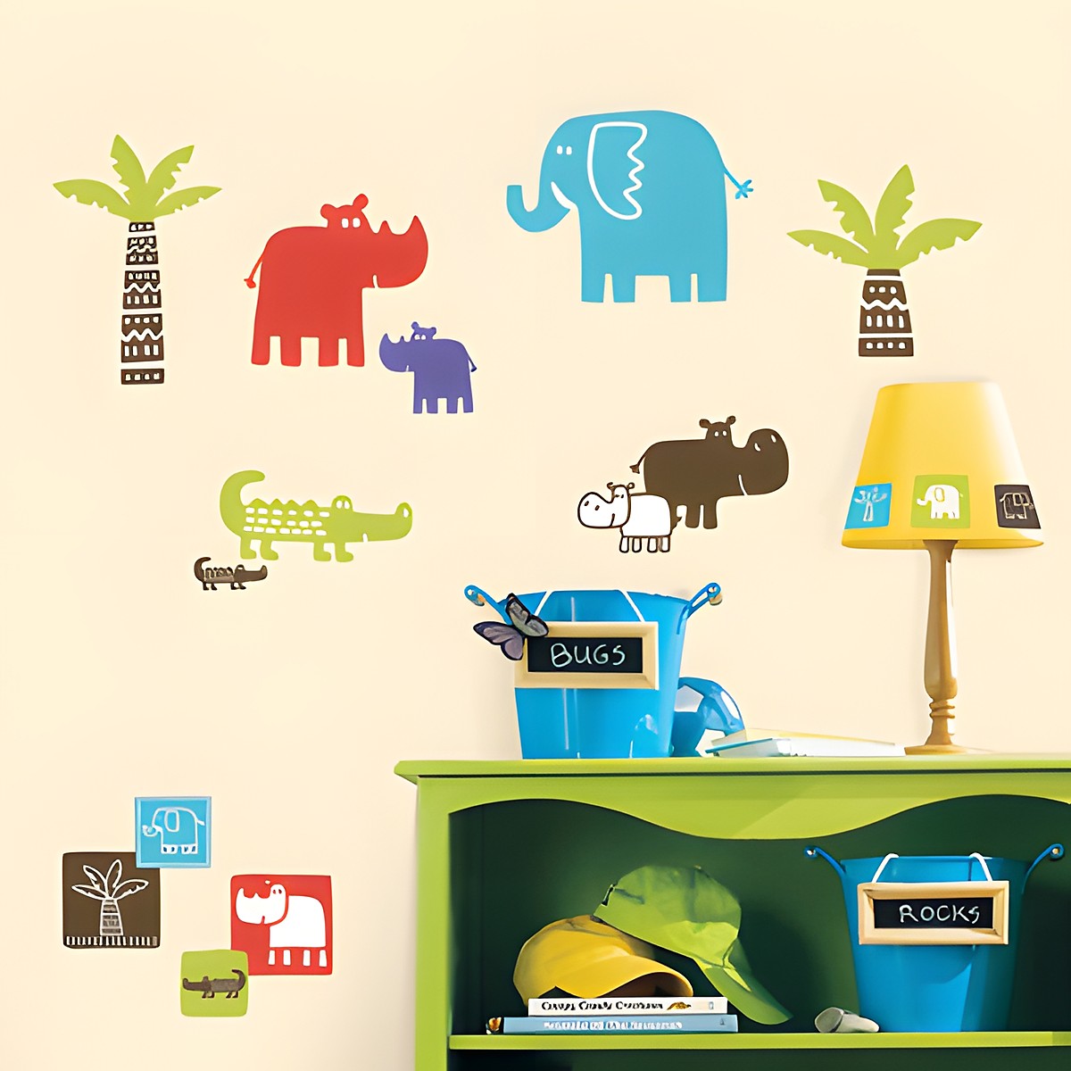 RoomMates wall decal Safari Blocks, graphic safari animals such as elephant, rhino and crocodile with palm trees on a cream-coloured children's room wall above a chest of drawers