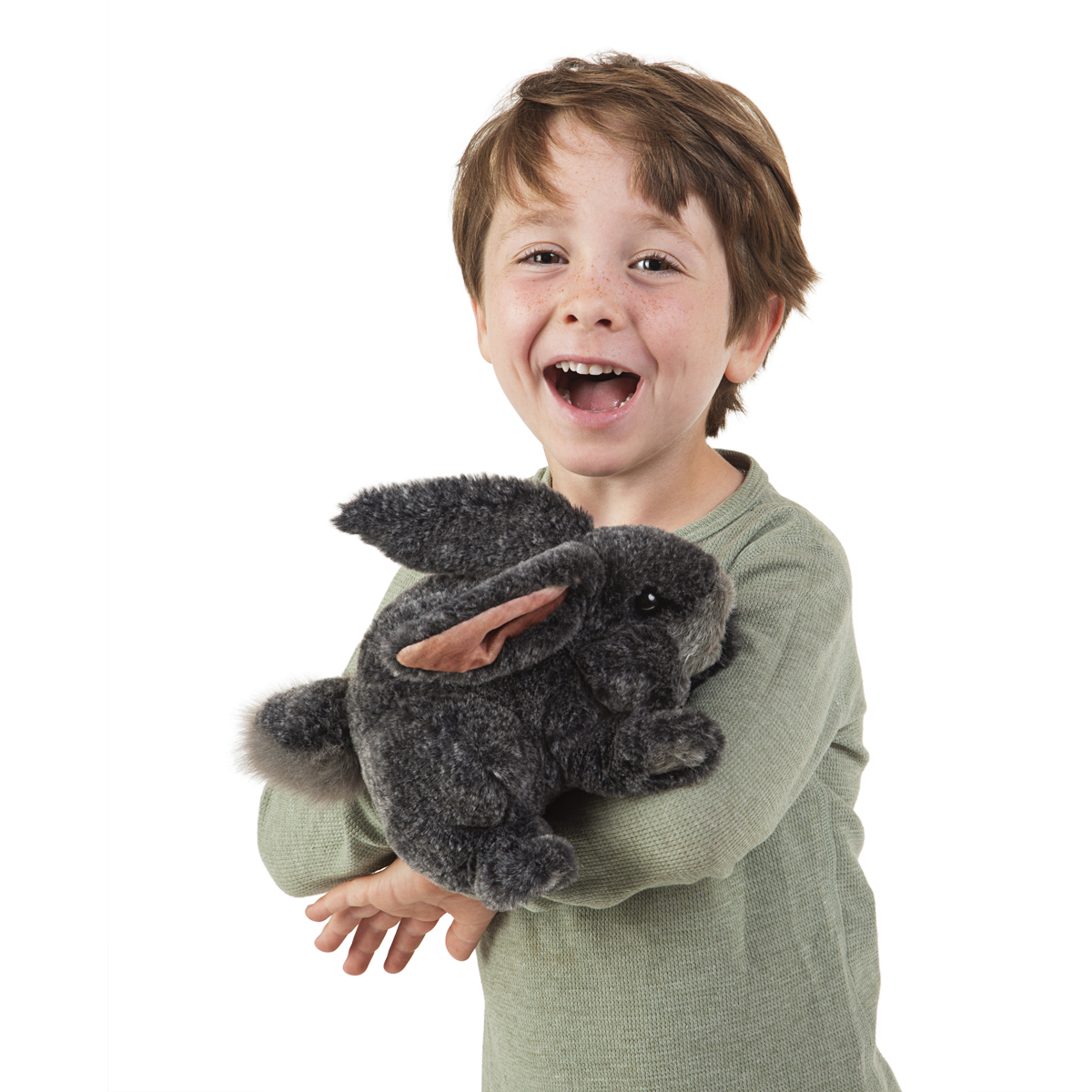 Laughing boy holding a grey Folkmanis hand puppet bunny with pink ears and fluffy fur in both hands