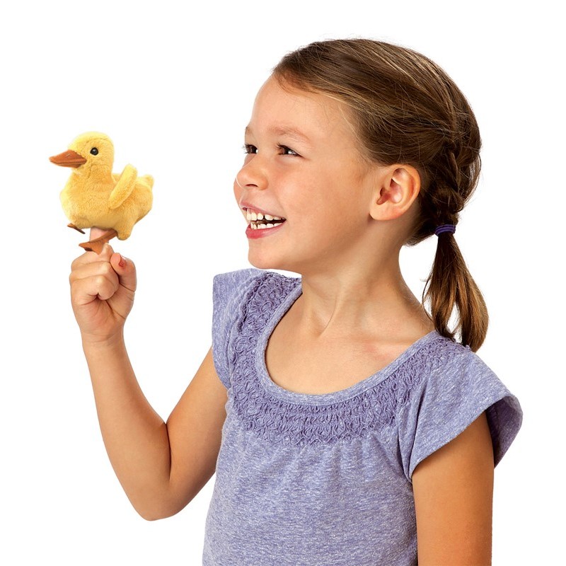 Girl holding a yellow Folkmanis mini duckling finger puppet on her index finger and laughing